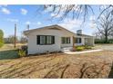 Lovely one-story home featuring a white brick exterior, black shutters, and a well-manicured lawn at 860 Main St, Lillington, NC 27546