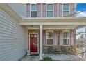 Inviting front porch with stone accents, seating, and a red front door at 151 New Castle Ln, Spring Lake, NC 28390