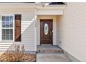 Close-up of the front door featuring stylish wood door with decorative glass at 199 Carolina Oaks Dr, Linden, NC 28356