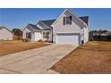 Classic one-story house featuring white siding, brown shutters, and a two-car garage at 199 Carolina Oaks Dr, Linden, NC 28356