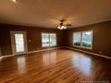 Open living room boasts hardwood floors, natural light, and a ceiling fan at 210 E E St, Erwin, NC 28339