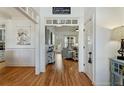 Bright foyer featuring hardwood floors, white wainscoting, and an open view into the living room at 42 Walnut Grove Dr, Bunnlevel, NC 28323