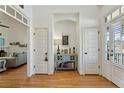 Elegant foyer with hardwood floors, white trim, an archway and a console table with books at 42 Walnut Grove Dr, Bunnlevel, NC 28323