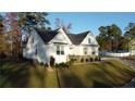 Well-maintained home on a lush lawn boasts appealing architectural details and landscaping at 503 Boulderbrook Pkwy, Sanford, NC 27330