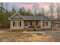 Charming single-story home featuring a cozy front porch, neutral siding, and well-maintained landscaping at 640 Lanier Farm Rd, Sanford, NC 27330