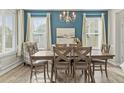 Elegant dining room with chandelier, large window and hardwood floors at 100 Tripoli Dr, Cameron, NC 28326