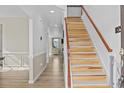 Welcoming entryway with hardwood floors and staircase leading to the upper level at 100 Tripoli Dr, Cameron, NC 28326