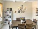 Formal dining room with hardwood table, chandelier, and a bookshelf creates an inviting atmosphere at 109 Mosby Ln, Spring Lake, NC 28390