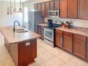 Well-equipped kitchen with stainless steel appliances, an island sink, and ample cabinet space at 109 Mosby Ln, Spring Lake, NC 28390