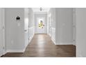 Bright hallway featuring light gray walls, hardwood floors and white paneled wainscoting at 19 Double Barrel St, Lillington, NC 27546