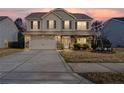 Charming two-story home with a stone and vinyl facade, covered porch, two-car garage, and landscaped yard at 190 National Dr, Clayton, NC 27527