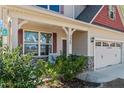 Charming home featuring stone accents, a covered porch, and a two-car garage at 220 Pender Rd, Spring Lake, NC 28390