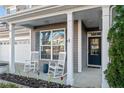 Charming front porch with rocking chairs, decorative accents and a glass door, creating a welcoming entrance at 278 Bandana Way, Cameron, NC 28326