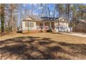 Cozy home featuring an attached garage, manicured yard, and an inviting covered front porch at 7053 Maple Cir, Sanford, NC 27332