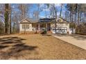 Single Gathering home with a covered porch, two-car garage, and a well-maintained front lawn at 7053 Maple Cir, Sanford, NC 27332