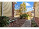 Charming home exterior showcasing a bench, walkway, and a well-maintained landscape at 82 Pine Hawk Dr, Spring Lake, NC 28390