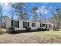 Inviting single-story home showcasing mature landscaping, enhancing the home's curb appeal with classic design at 121 H B Dr, Spring Lake, NC 28390