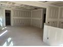 Unfinished living room featuring installed drywall, space for natural light, and open floor plan at 122 Reece Dr, Sanford, NC 27332