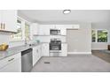 Modern kitchen with stainless steel appliances, white cabinets, and granite countertops at 500 S 13Th St, Erwin, NC 28339