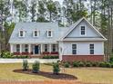 Charming two-story home with gray siding, dormers, and well-manicured landscaping at 515 Sanctuary Trl, Cameron, NC 28326