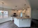 Open kitchen with granite countertops, stainless steel appliances, and white cabinets at 81 Reece Dr, Sanford, NC 27332