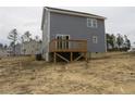 Exterior rear view of home with a wooden deck, sliding glass doors and large backyard at 932 Allstar Ave, Cameron, NC 28326