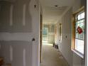 Bright hallway featuring natural light, drywall, and visible framework at 932 Allstar Ave, Cameron, NC 28326