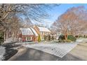 Lovely traditional home featuring manicured landscaping, brick exterior, and a snow-covered roof in a serene setting at 105 Royal Glen Dr, Cary, NC 27518