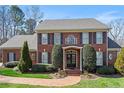 Charming two-story brick home featuring classic shutters, manicured landscaping, and a welcoming front entrance at 105 Royal Glen Dr, Cary, NC 27518