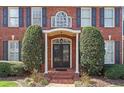 Close-up of the front entrance, featuring elegant double doors and decorative shrubbery at 105 Royal Glen Dr, Cary, NC 27518