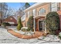 Charming brick home featuring a walkway to a covered front entrance with ornate double doors at 105 Royal Glen Dr, Cary, NC 27518