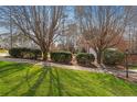 A neatly landscaped yard with trimmed bushes and mature trees lining the sidewalk at 105 Royal Glen Dr, Cary, NC 27518