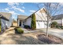 Inviting single-Gathering home showcasing a well-kept lawn and a double-car garage at 1111 Axelwood Ln, Durham, NC 27703