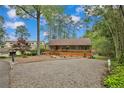 Charming home with a welcoming front porch, steps, wood accents and professionally landscaped yard at 1393 Pennsylvania Ave, Sanford, NC 27332