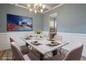 Elegant dining room featuring wainscoting, modern chandelier, and ample seating at 169 Kensington Dr, Spring Lake, NC 28390