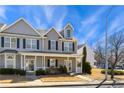 Inviting two-story townhome with a charming front porch and well-maintained landscaping at 3931 Volkswalk Pl, Raleigh, NC 27610