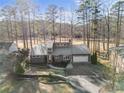 An elevated view of a single-story home featuring a metal roof, gray siding and attached garage at 527 Perth Dr, Sanford, NC 27332