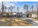 Beautiful single-story home featuring a metal roof, gray siding and an attached two-car garage at 527 Perth Dr, Sanford, NC 27332