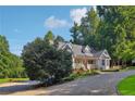 Attractive single-story home with dormers, metal roof, bay windows, an American flag and a circular driveway at 609 Cashmere Ct, Sanford, NC 27332