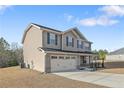 This two-story home features a two-car garage, inviting front porch, and meticulous landscaping at 715 New Castle Ln, Spring Lake, NC 28390