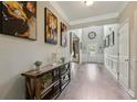 Bright foyer with hardwood floors, high ceilings, and an artistic display on the wall at 718 Creekside Dr, Sanford, NC 27330