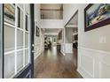 Elegant foyer with hardwood floors, detailed molding, art, and an open view to the upper level at 718 Creekside Dr, Sanford, NC 27330