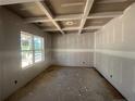 Bedroom with a decorative tray ceiling, unfinished walls, and a large window offering natural light at 84 Peach Orchard (Lot 4) Ln, Lillington, NC 27546