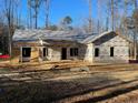 New construction home with OSB and house wrap, ready for siding, showcasing its architectural structure at 84 Peach Orchard (Lot 4) Ln, Lillington, NC 27546