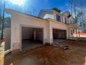 Exterior shot of three-car garage with unfinished interiors, highlighting ample parking and storage space at 96 Peach Orchard (Lot 5) Ln, Lillington, NC 27546