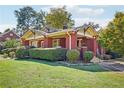 Attractive brick home featuring a covered front porch and well-maintained lawn and landscaping at 205 N Gulf St, Sanford, NC 27330