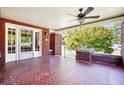 Spacious front porch with brick pillars and tile flooring, ideal for enjoying the outdoors at 205 N Gulf St, Sanford, NC 27330