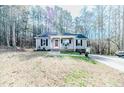 Charming single-story home with a well-manicured lawn and inviting front porch at 2609 Mill Creek Ct, Sanford, NC 27330