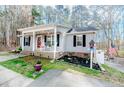 Inviting single-story home with charming front porch and well-maintained landscaping at 2609 Mill Creek Ct, Sanford, NC 27330