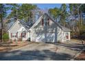Inviting single-Gathering home featuring a two-car garage, well-maintained lawn and mature trees in a residential area at 48 Cedar Ln, Sanford, NC 27332